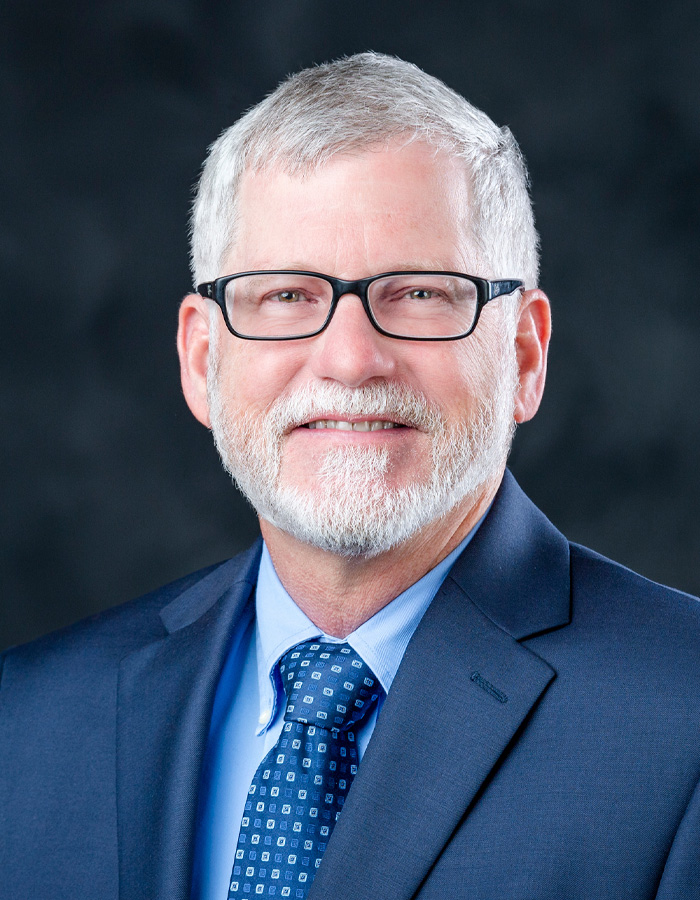 Formal studio headshot portrait of Chris Bryant