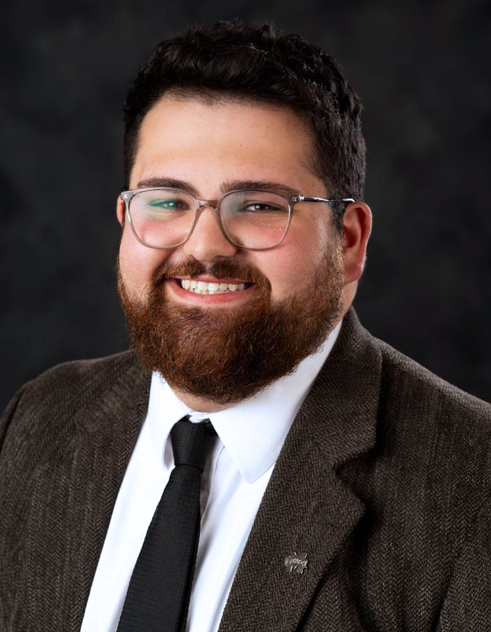 Formal studio headshot portrait of Jonah Holland